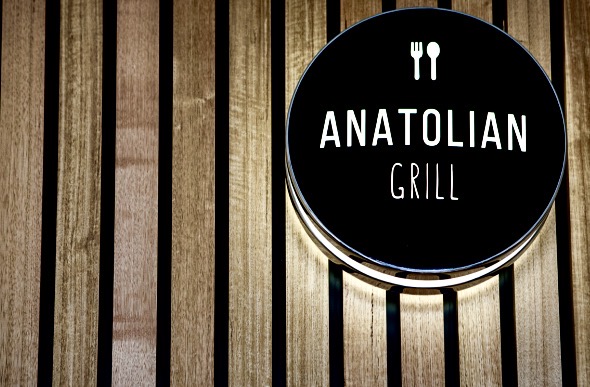 Anatolian Grill circular sign on timber slats